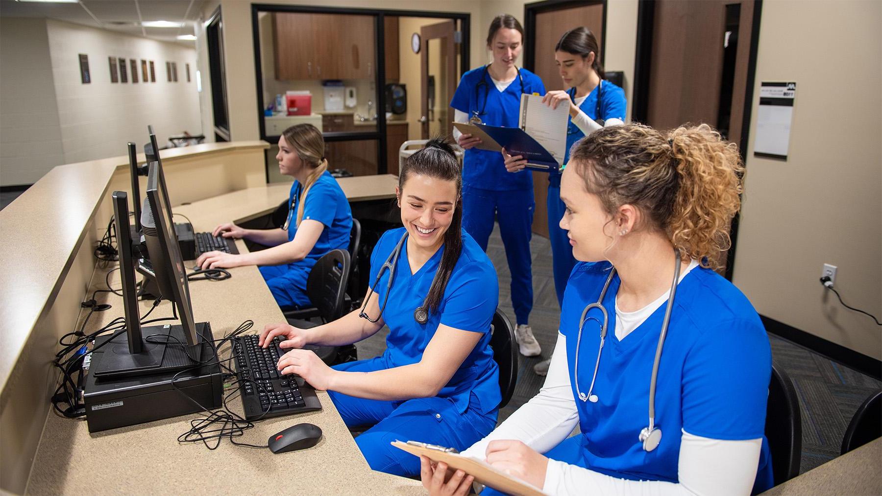 Nursing students working in the sim labs