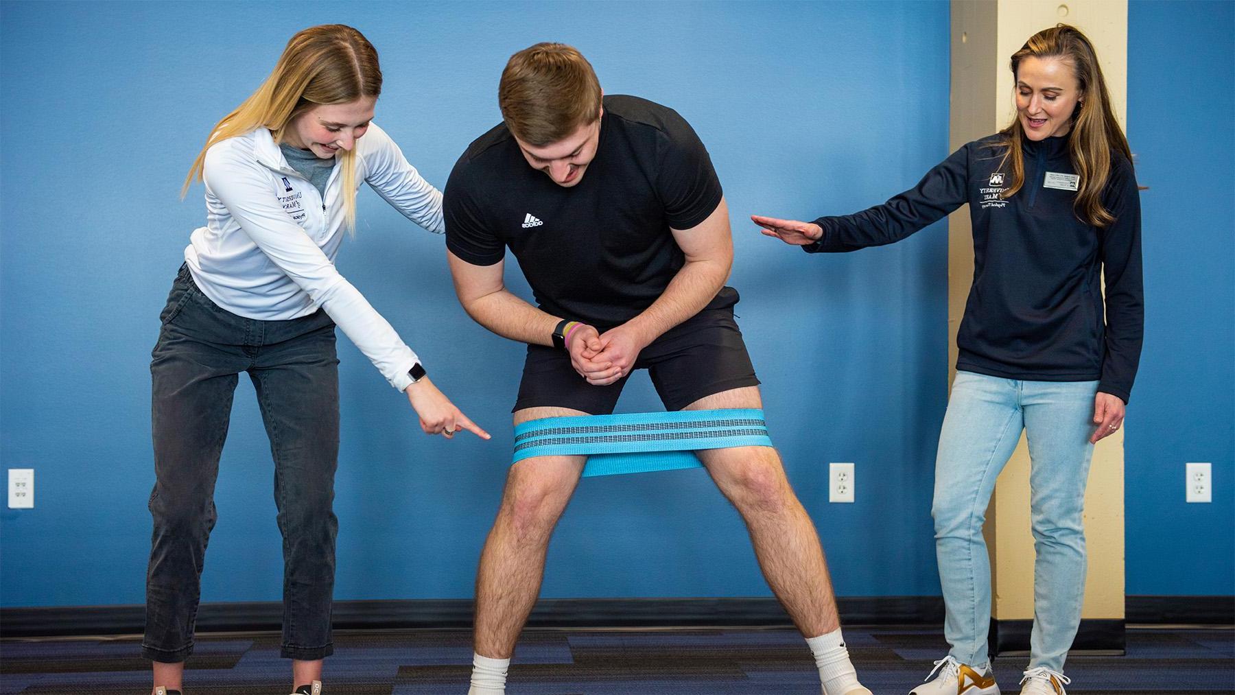 Students practicing with a PT band